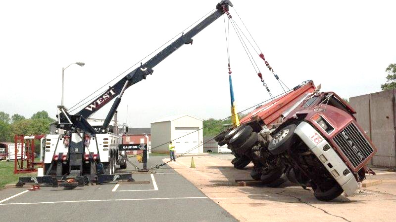 Throwback picture of a rotator training class picking up a Mack Truck. 